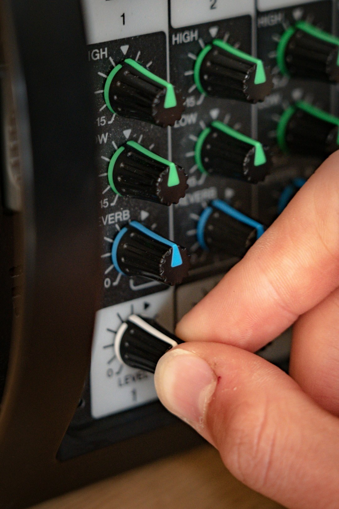 British male broadcast instructor operating a video switcher panel