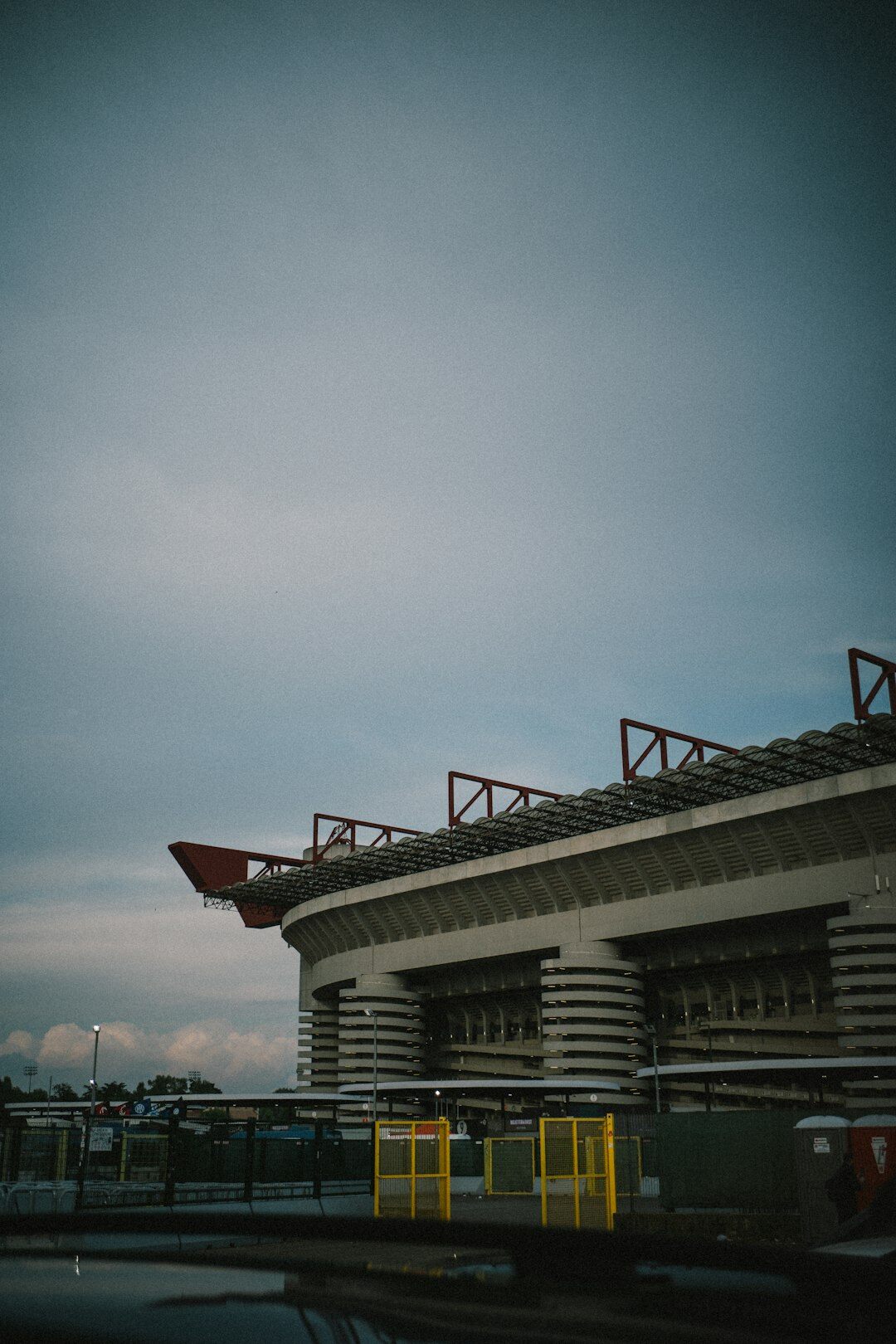 Outside broadcast van with satellite dish parked beside a stadium